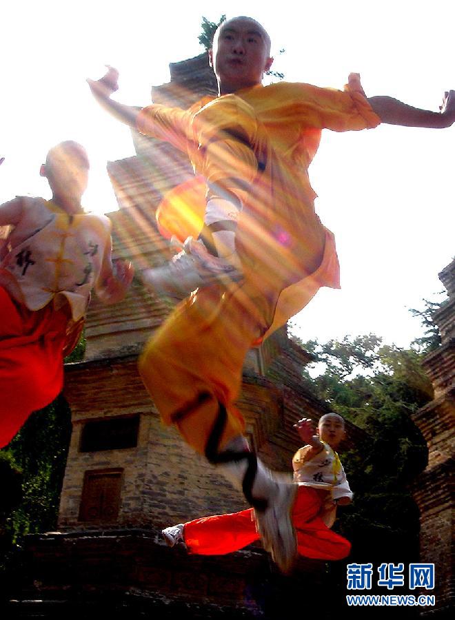 3名武僧正在少林寺塔林附近演练少林拳法(2004年7月26日摄).